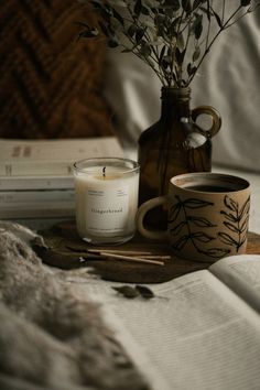 a candle and some books on a bed