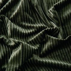 an up close shot of a green striped fabric