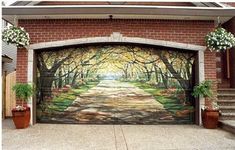 a painting on the side of a garage door that is decorated with flowers and trees