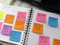 a notebook with sticky notes attached to it