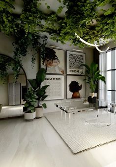 a living room filled with lots of plants and pictures hanging on the wall above it