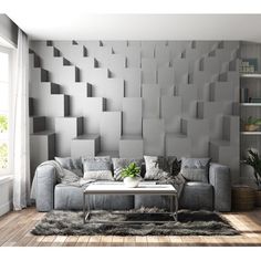 a living room with a couch, coffee table and bookshelf on the wall