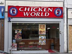 a chicken world restaurant on the corner of a street