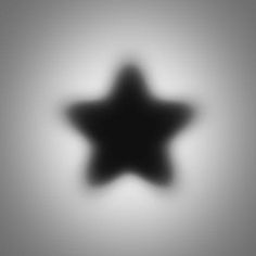 a black and white image of a star on a gray background with the light reflecting off it's side