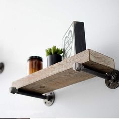 the shelf is made out of wood and has two metal brackets on each side, holding various items