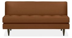 a brown couch sitting on top of a white floor