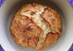 a loaf of bread in a white bowl