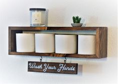 a wooden shelf with candles and a sign that says have a nice poop