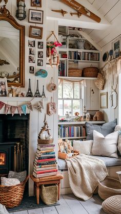 a living room filled with lots of furniture and books on the wall next to a fire place