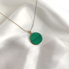 This stunning Pendant is set in 14k Solid Yellow Gold with Natural Malachite with utmost precision. It is a unique gemstone Pendant for nearly every occasion and is completely hassle-free jewelry. ITEM DETAILS: * Gem: Malachite * Gem Size: 20X20mm * Gem Shape: Round Flat Cut * Gem Weight: 18.29 carats * Gold Purity: 14KT * Gold Weight: 0.68 gram * Total Weight: 4.33 gram The Gold purity is guaranteed and it comes with authentic 14KT gold hallmark. Since my items are handmade, they are absolutely nickel and lead free. CUSTOMIZATION: * Gemstone customization is available and it can be substituted with a gem of your choice. Kindly message me for the same. PACKAGING * The Pendant comes with layers of safe and secure wrapping along with Free handmade jewelry box with every purchase. ➡️Head to t Tarnish Resistant Green Round Jewelry, Green Tarnish Resistant Round Jewelry, Gold Malachite Jewelry For May Birthstone, Yellow Gold Green Onyx Gemstone Jewelry, Malachite Round Gemstone Jewelry, Round Malachite Gemstone Jewelry, Gold Malachite Gemstone Jewelry, Gold Malachite Round Necklace, Green Onyx Round Gemstone Jewelry