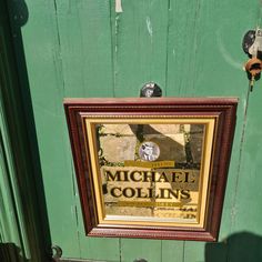 there is a framed sign that says michael collin's on the front door