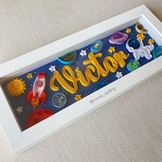 an art piece with the word space spelled in yellow letters and surrounded by other colorful objects