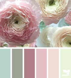 the color scheme is pale, pink and green with white flowers in it's center