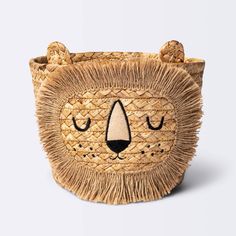 a small animal made out of straw with eyes and ears on it's head