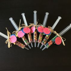 a bunch of candy sticks sitting on top of a black table next to each other