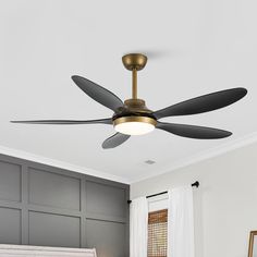 a ceiling fan with three blades in a bedroom