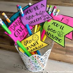 a basket filled with lots of writing and markers