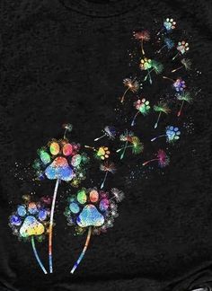 a black t - shirt with colorful dandelions on it