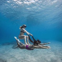 two women are swimming in the ocean together