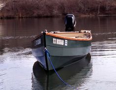 a small boat sitting on top of a body of water