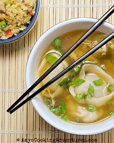 two bowls of soup with chopsticks next to each other on a table top