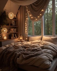 an unmade bed in front of a window with lights strung from the windowsill