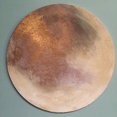 a round metal plate on a blue wall