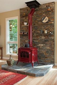 a red stove sitting in the middle of a living room