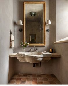 a bathroom sink sitting under a large mirror