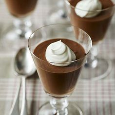 two glasses filled with chocolate pudding and whipped cream