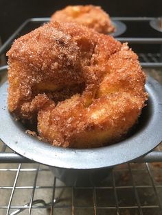 two sugared donuts sitting on top of a metal pan