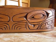 a carved wooden bowl sitting on top of a table