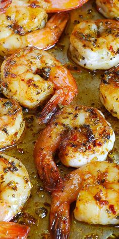 cooked shrimp and carrots in a skillet with oil on the bottom, ready to be eaten