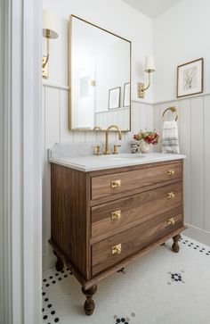 a bathroom with two sinks and mirrors on the wall