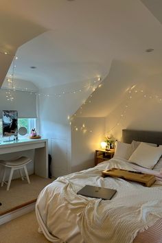 a bedroom with white walls and lights on the ceiling