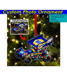 an ornament is hanging from a christmas tree with the image of a racing car