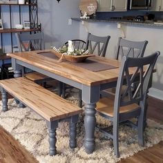 a dining room table with two benches and a bowl of flowers on the centerpiece