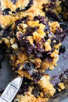 blueberry cobbler on a plate with a spoon