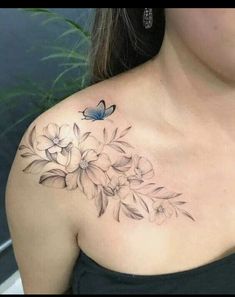 a woman with a butterfly and flowers tattoo on her chest