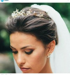 a woman in a wedding dress with a veil on her head wearing a tiara