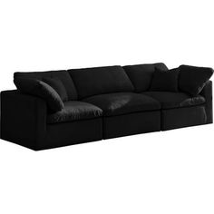 a black couch with two pillows on it's back and one arm folded out