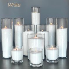 white candles are lined up next to each other