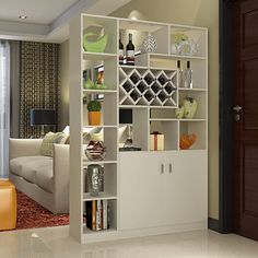 a living room filled with furniture and a book shelf in front of a sliding glass door