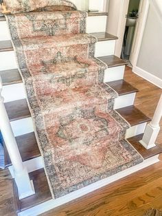 a carpeted staircase leading up to an open door