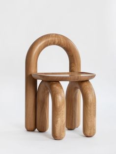 a wooden chair and stool made out of wood with an arch on the top, sitting in front of a white background