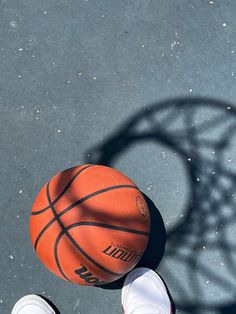 an overhead view of a person's feet with a basketball in front of them