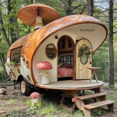 a tiny house in the woods with mushrooms on it