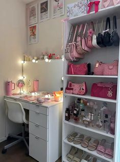 a white desk topped with lots of pink bags and purses next to a wall mounted mirror