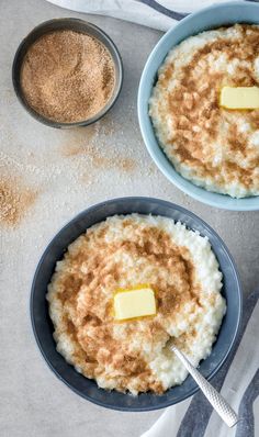 two bowls filled with rice and topped with butter