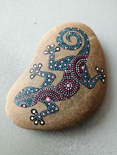 a rock with a lizard painted on it